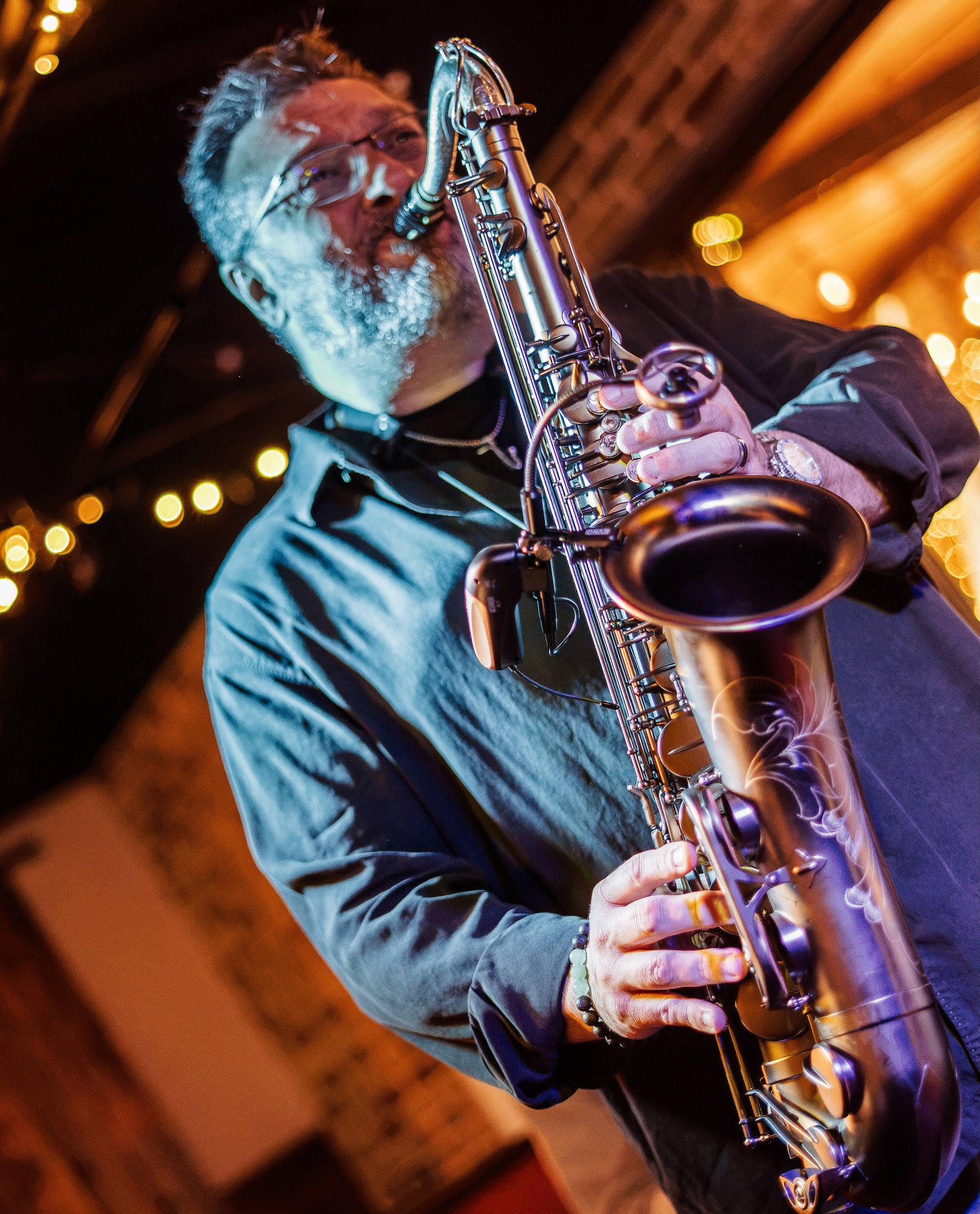Mike MacArthur playing saxophone on stage.
